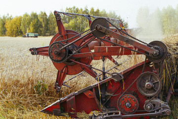 Combine harvester on the wheat field