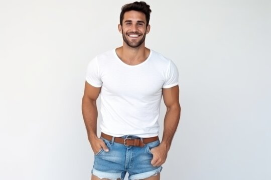 Handsome Young Man In White T-shirt And Denim Shorts Standing Over White Background