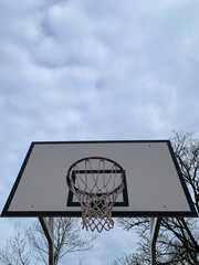 basketball hoop against blue sky, no person