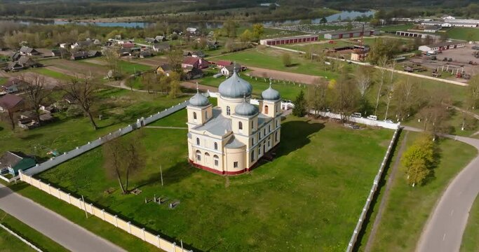 aerial view and full flyby over old new orthodox church in countryside