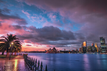 Sydney Skyline with the Opera House next to the city centre during sunrise with dramatic sky during...