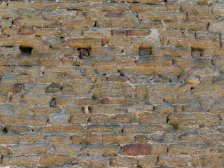 Dry stone wall texture, in the Provence style (France) around Bormes-les-Mimosas village, with a several deadeye holes visible