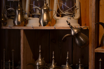 Fototapeta na wymiar Traditional Arabic coffee pots om wooden shelfs.