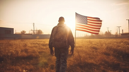 Back view of an AMERICAN soldier carrying an AMERICAN flag for Veteran Day