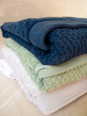 Composition with bath towels. Closeup of a Pile bath towels on beige background. Close-up. Bath concept.