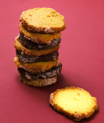 A set of cookies with lemon and pumpkin seeds flavor, lavender flavor and pistachio-chocolate icing, in a gift box. Close-up