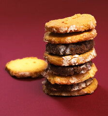 A set of cookies with lemon and pumpkin seeds flavor, lavender flavor and pistachio-chocolate icing, in a gift box. Close-up