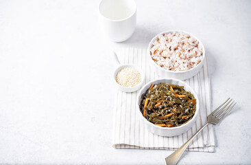 Seaweed with carrot and sesame seeds in a bowl