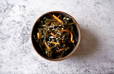 Seaweed with carrot and sesame seeds in a bowl © nata_vkusidey