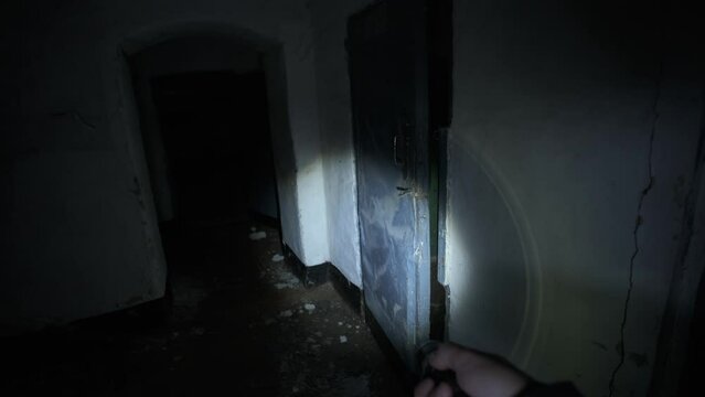 Man finding ghost with cage on his head in basement of abandoned asylum POV shot