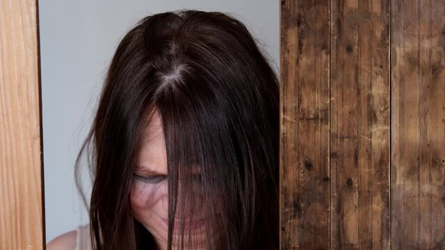 close-up of female tear-stained face, beaten woman with bruises and abrasions, quiet cry for help, concept of domestic violence, emotion of suffering from pain, kidnapping, being in danger