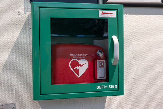 Halmstad, Sweden - February 18 2023: Ready to use defibrilator in a green box.