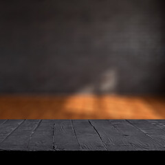 Black wooden table with black wall 