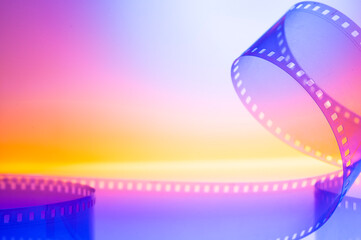 abstract colored cinematic background with film strip.background banner for film premiere festivals...
