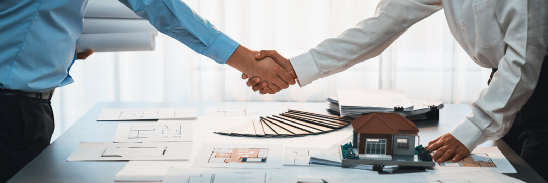 Interior designer shake hand with client or colleagues after made successful sketching and choosing mood board materials or color selection for modern house interior design. Insight