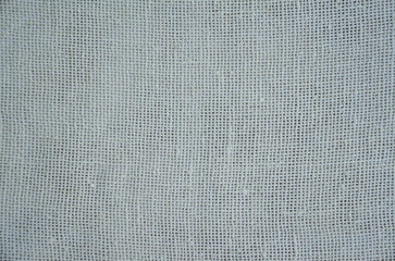 Textured background made of light-colored fabric