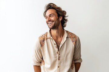 man in his 30s that is wearing a flowy bohemian blouse against a white background