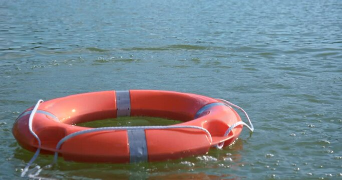Safety on the water. A drowning person and a lifebuoy thrown into the lake. Drowning in vacation on a sunny day, sink.