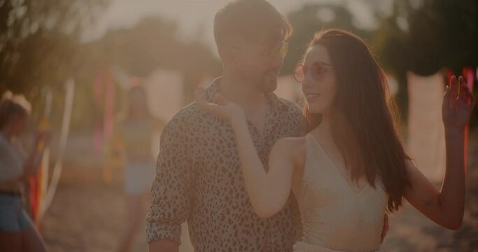 Happy man looking at girlfriend grooving to music
