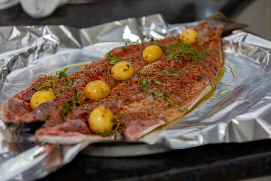 Traditional anchovy fish (Pomatomus saltador) seasoned ready to be baked in the oven