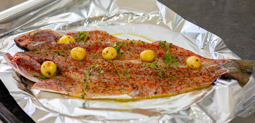 Traditional anchovy fish (Pomatomus saltador) seasoned ready to be baked in the oven