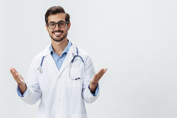 Man doctor in white coat and eyeglasses smile shows hand gestures signs on white isolated background looks into camera, copy space, space for text, health