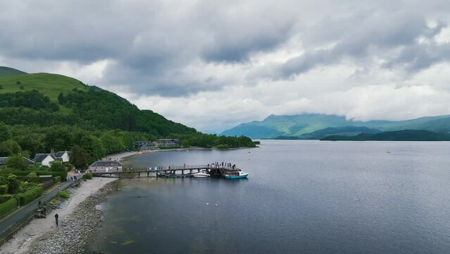 Mountains and Lake around Luss Village from a drone, Loch Lomond, Argyll and Bute, Scotland, UK