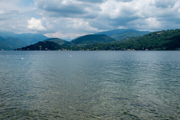 Orta Lake's waters summer panorama. Orta lake is a small water mirror, of glacial origin, situated in Northern Italy, Piedmont Region.