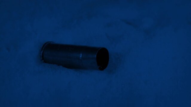 Bullet Shells Drop Into The Snow At Night