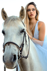 blonde girl riding a white horse