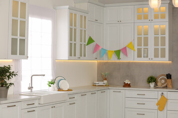 Stylish white kitchen with colorful decor. Interior design