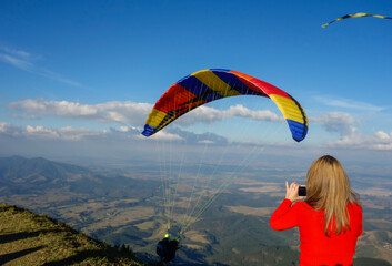 colored Paraglider taking off from Pico Agudo in Santo Antonio do Pinhal, SP, Brazil