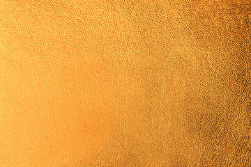 Golden textured surface as background, closeup view