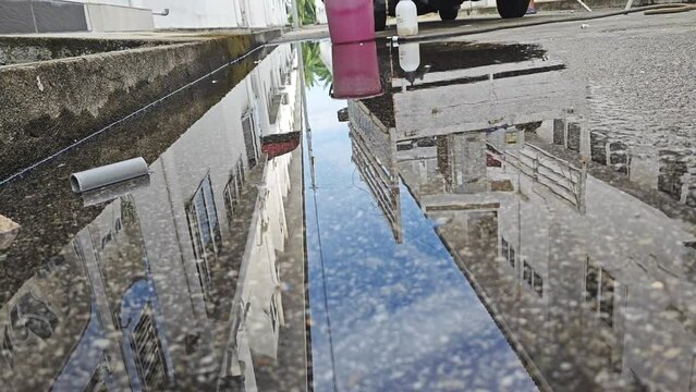 Reflective Stagnant Rain Water On The Asphalt Street