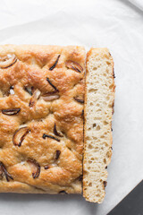 Top view of homemade onion focaccia on a white background, Flatlay of focaccia with red onion topping, fresh homemade focaccia bread