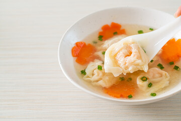 shrimp dumpling soup in white bowl