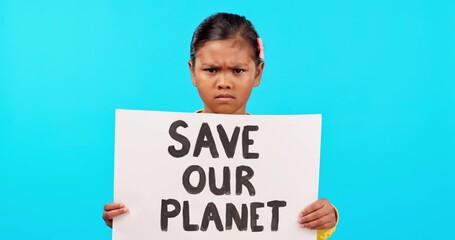 Girl, global warming and cardboard poster in studio, protest sign and vote to save the planet by blue background. Kid, billboard and portrait for climate change, environment warning and angry face