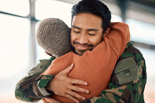Love, hug and a man soldier with his wife in the airport after returning home from war service as a patriot. Smile, military or army with a happy couple embracing as a welcome to safety and security