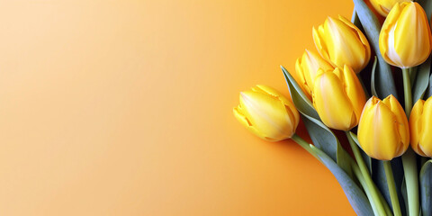 Bouquet of yellow tulips flower on orange background. Top view background with copy space