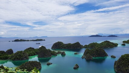 Fototapeta na wymiar View from the top of the Pianemo Islands, Blue Lagoon with Green Rocks, Raja Ampat, West Papua, Indonesia.