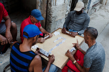 Latin group of elderly men playing dominoes in Old Havana Cuba, Caribbean black people