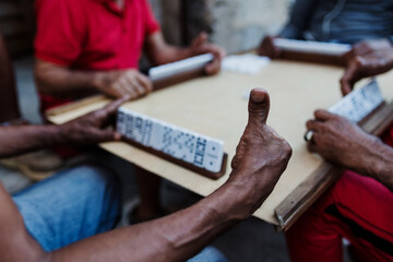 hands of group of elderly men playing dominoes in Old Havana Cuba, Afro Caribbean black people