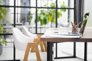 Stylish workspace with laptop, office supplies. Desk work concept.