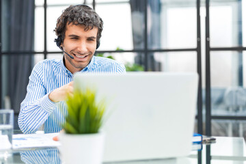 Smiling friendly handsome young male call centre operator.