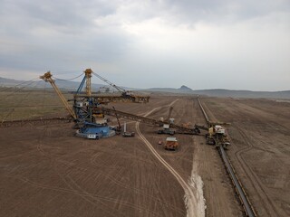 huge bucket wheel excavator digging operations in the brown coal mine in Most region of Czech republic,Europe,heavy machinery in recultivated landscape mine