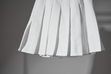 Mockup white pleated skirt, teenager girl school uniform on neutral gray background. Mock up
