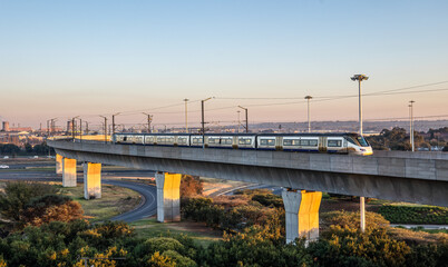 A high speed train on a raised track arrives at Johannesburg airport