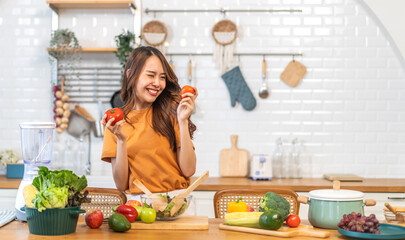 Portrait of beauty body slim healthy asian woman having fun cooking and preparing cooking vegan food healthy eat with fresh vegetable salad on counter in kitchen at home.Diet.Fitness, healthy food