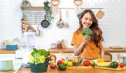 Portrait of beauty body slim healthy asian woman having fun cooking and preparing cooking vegan food healthy eat with fresh vegetable salad on counter in kitchen at home.Diet.Fitness, healthy food