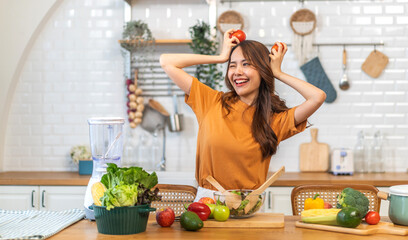Portrait of beauty body slim healthy asian woman having fun cooking and preparing cooking vegan food healthy eat with fresh vegetable salad on counter in kitchen at home.Diet.Fitness, healthy food